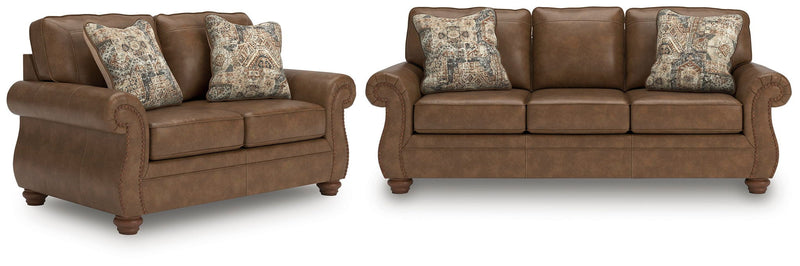 Living room set with dark brown loveseat and sofa, padded arms, patterned accent pillows
