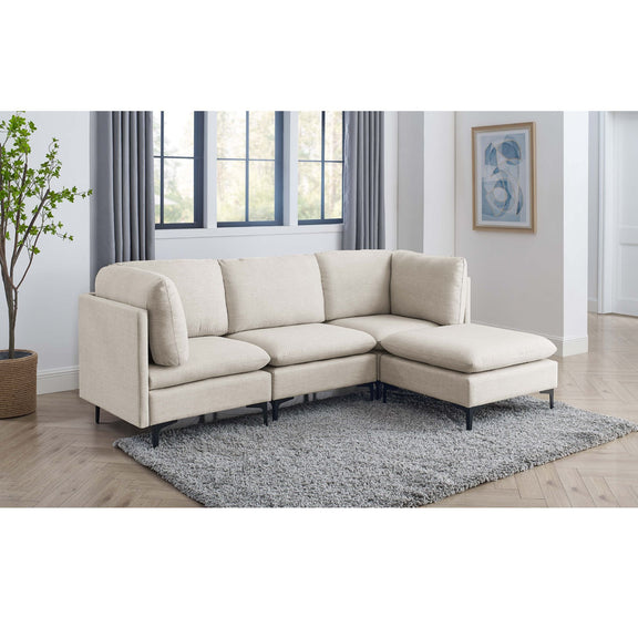 Beige modular sectional sofa with ottoman and tall black legs on gray area rug