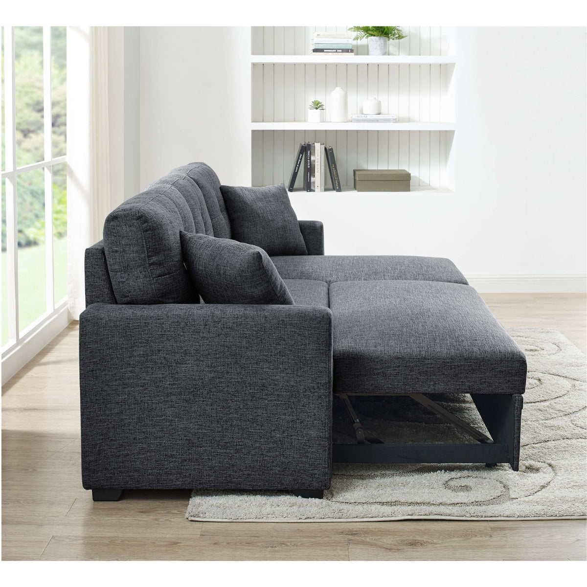 Dark gray sectional with pull-out bed extended and storage compartment under chaise