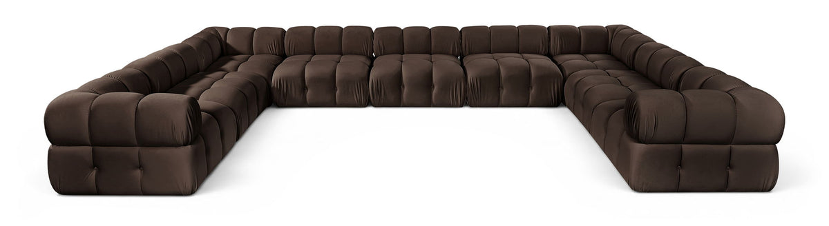 Dark brown velvet upholstered sectional sofa with tufted cushions and curved end arms