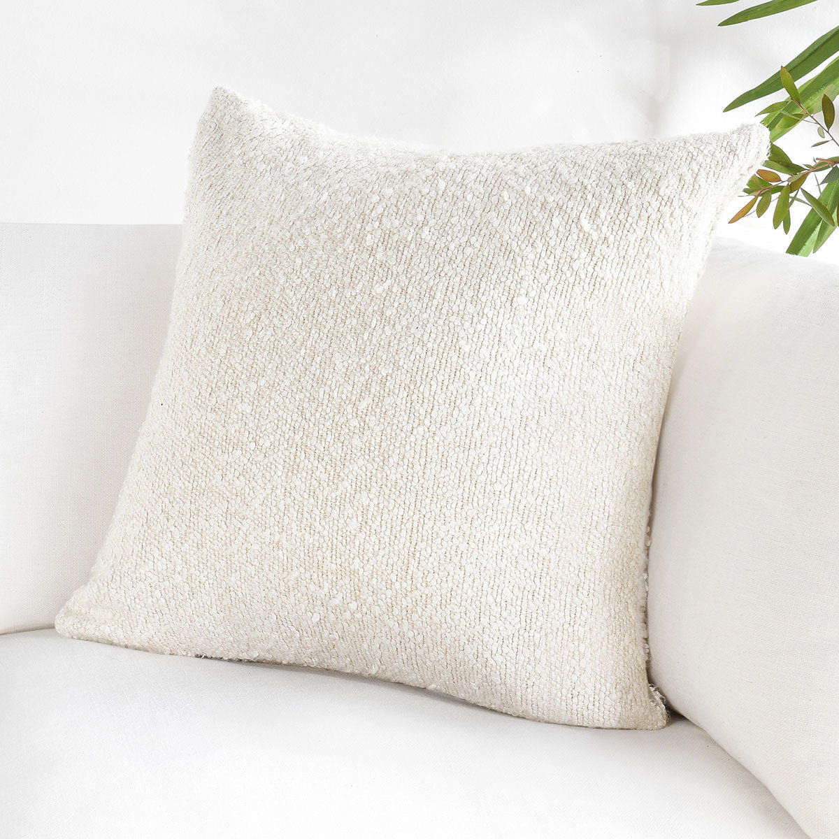 Ivory lumbar throw pillow with chunky textured weave and neutral fabric finish