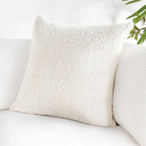 Ivory lumbar throw pillow with chunky textured weave and neutral fabric finish
