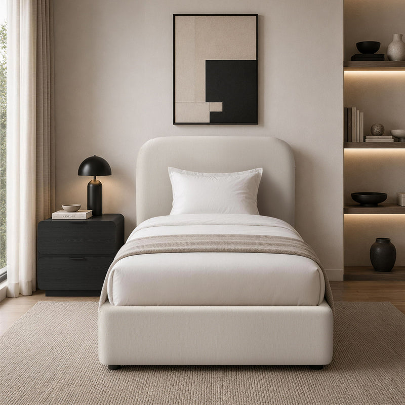 Beige upholstered bed with rounded headboard and white bedding in a modern room