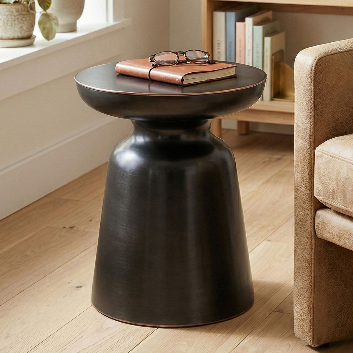 Dark metal round bell accent table with flared top and tapered pedestal