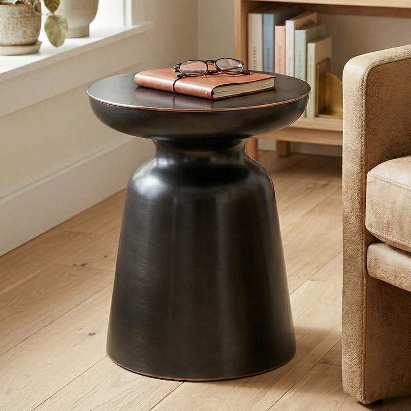 Dark metal round bell accent table with flared top and tapered pedestal