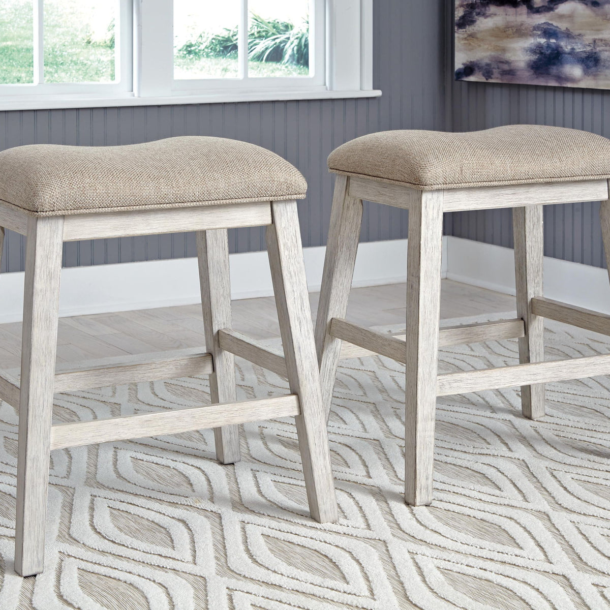 Set of 2 upholstered bar stools with light beige seats and weathered gray legs