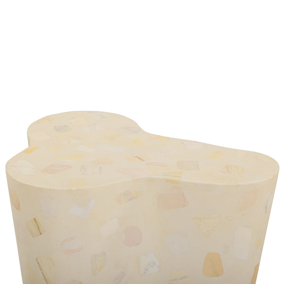 Beige terrazzo-pattern side table with curved body and rounded top