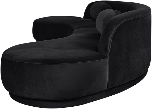 Black velvet sectional sofa with curved armrest and chaise-style seat