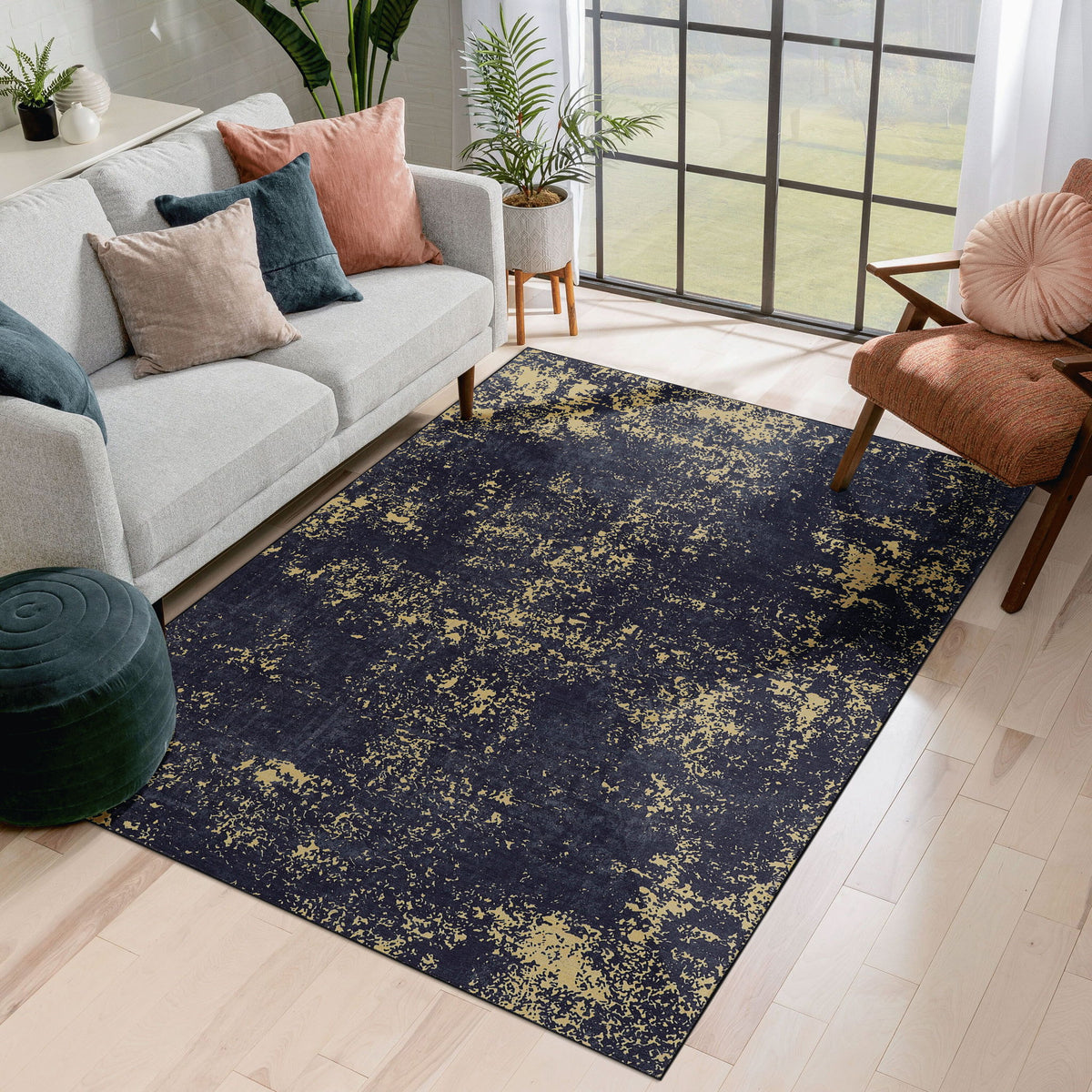 Washable area rug with dark navy and gold speckled abstract pattern, rectangular