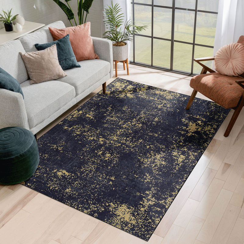 Washable area rug with dark navy and gold speckled abstract pattern, rectangular