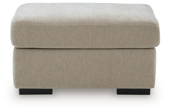 Light brown upholstered ottoman with rounded lid and dark legs
