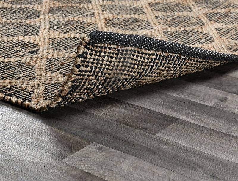 Mojave rug corner detail showing woven border and layered edge in black and natural