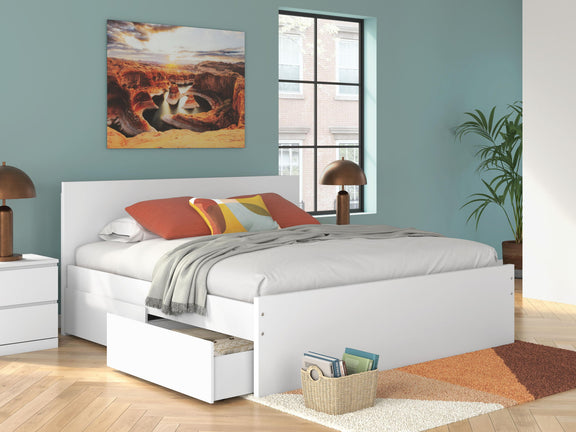 White panel platform bed with slatted base, headboard, and bedding set