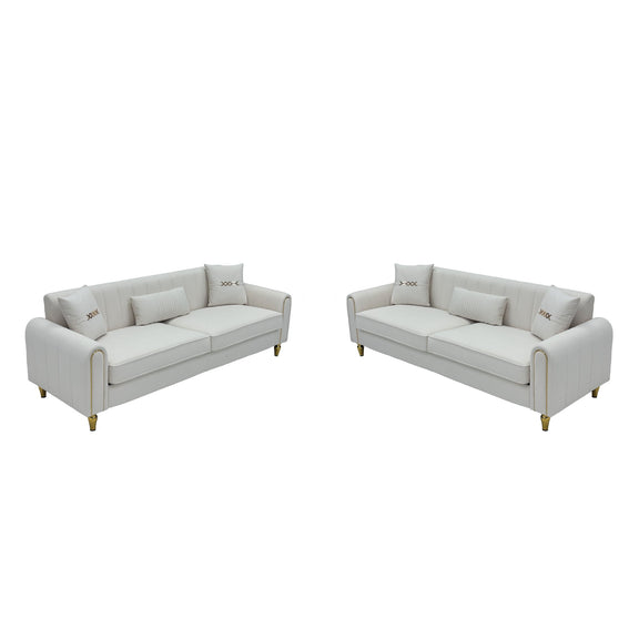 Two-piece sofa set with two light-colored three-seat sofas and gold-tone legs