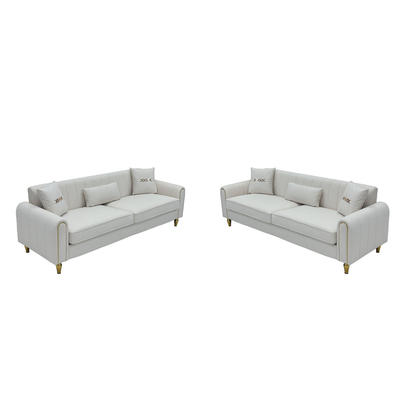 Two-piece sofa set with two light-colored three-seat sofas and gold-tone legs