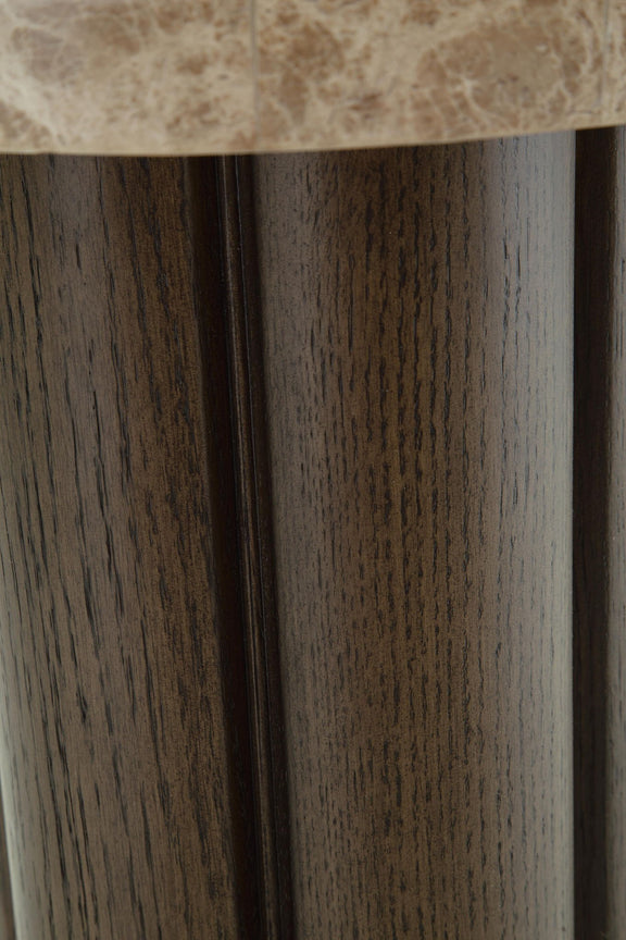 Close-up of dark brown wood pedestal legs with textured vertical grain