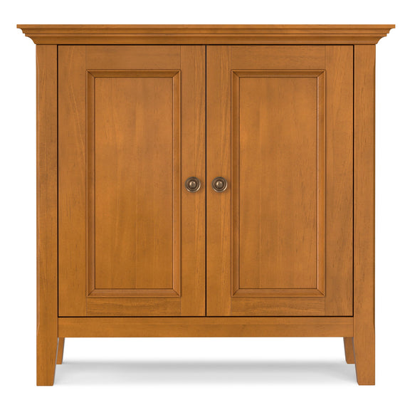 Low storage cabinet with two wood doors, raised panels, and round knobs