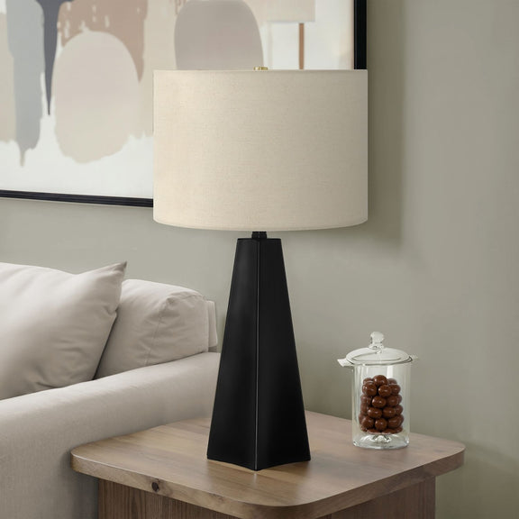 Black resin table lamp with off-white fabric drum shade