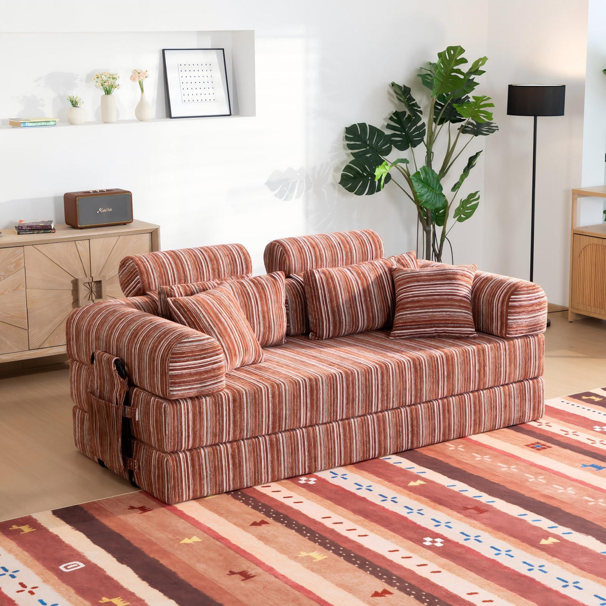 Red striped convertible sleeper sofa with rolled arms and stacked back pillows
