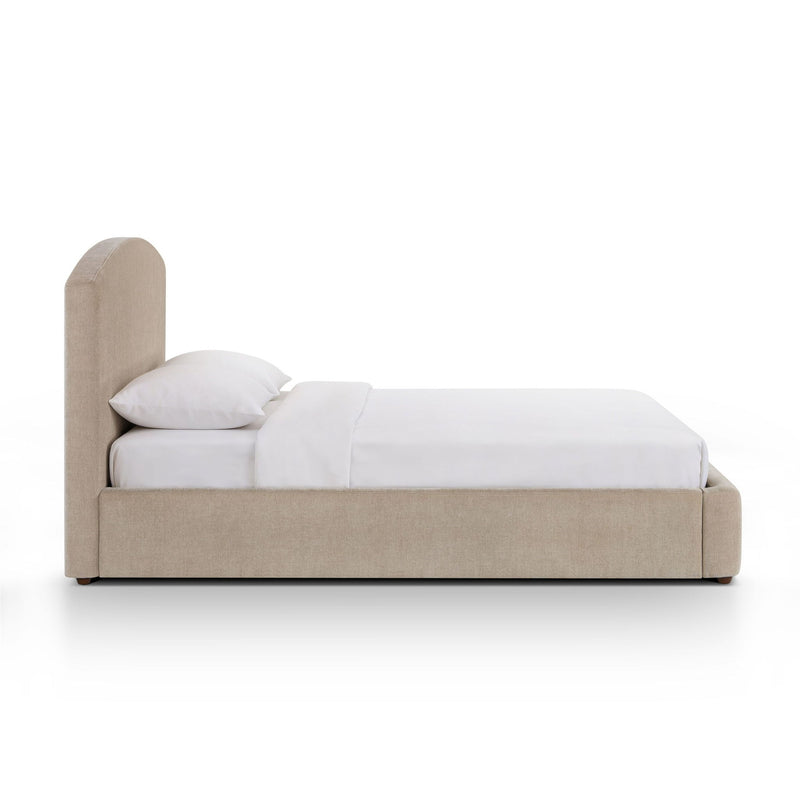 Upholstered platform bed with arched headboard, beige frame, white bedding set.