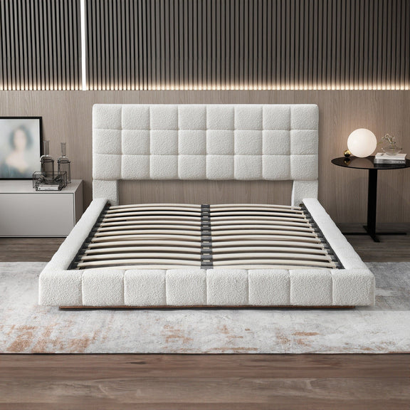 Beige bed with tufted headboard and slatted base, styled with striped bedding