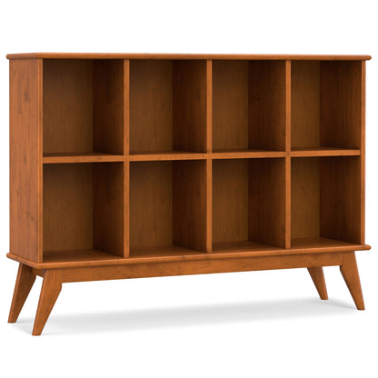 Light brown low bookcase with open cubby shelves and five vertical dividers.