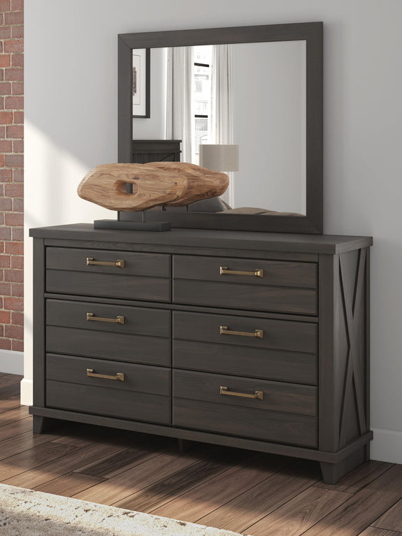 Dark brown six-drawer dresser with matching framed mirror, shown in a room setting