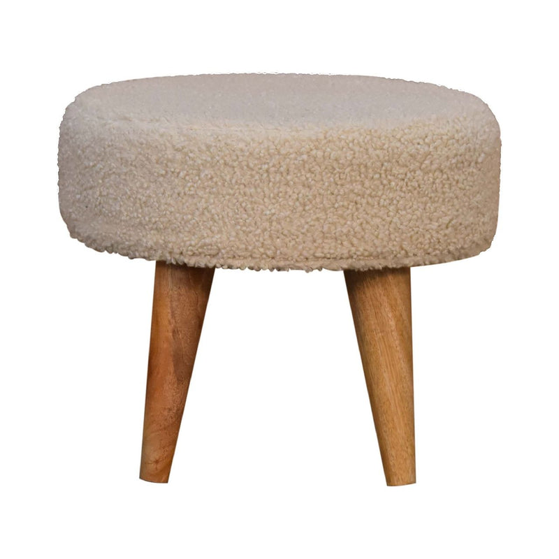 Cream boucle upholstered round footstool on four wooden legs
