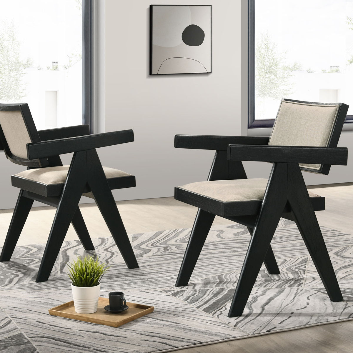 Ebony black arm chairs with light beige cushions and round console table