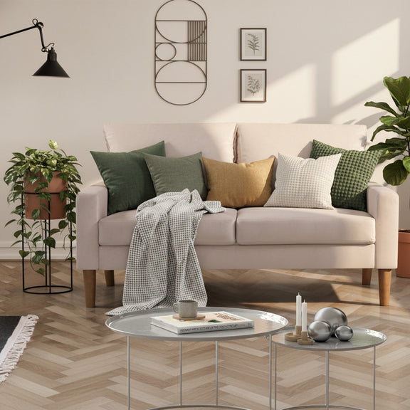 Upholstered 2-seater loveseat sofa in light upholstery with two back cushions and wooden legs