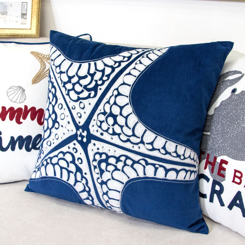 Indigo blue pillow cover with white starfish motifs and navy corner border