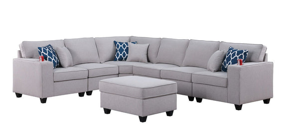 Gray sectional sofa with ottoman and blue patterned throw pillows, curved corner layout