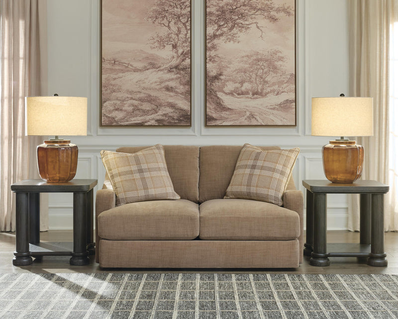 Beige loveseat with plaid accent pillows and solid back cushions