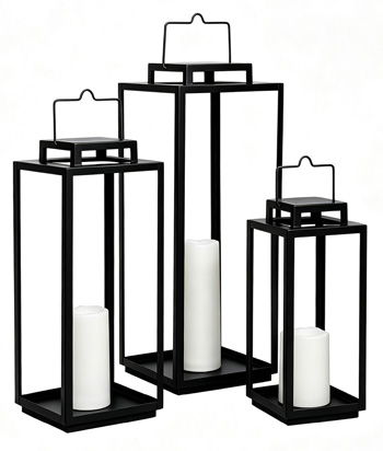 Set of three black metal outdoor lanterns with glass panels and pillar candles