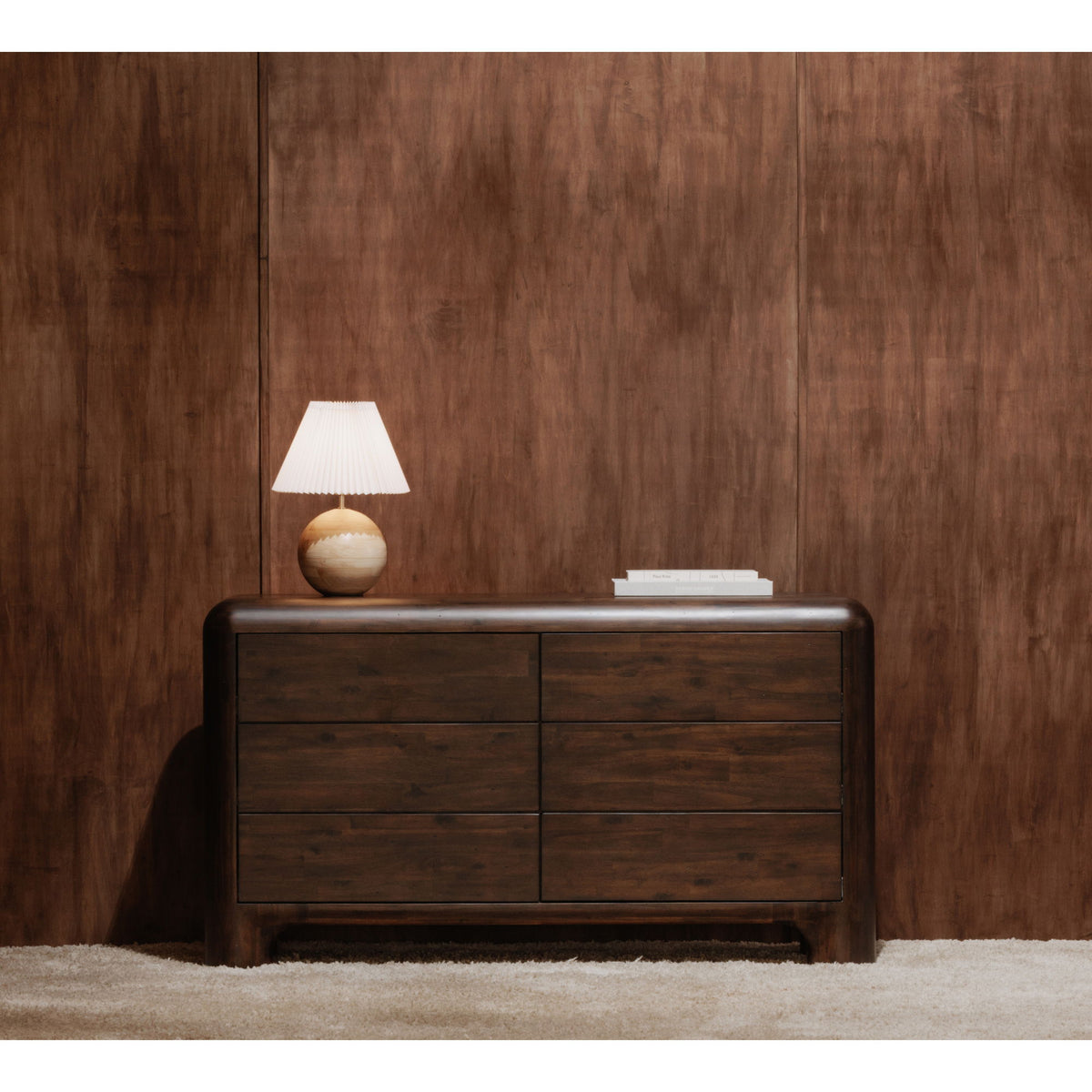 Dark brown six-drawer dresser with lamp on top and four visible drawer fronts