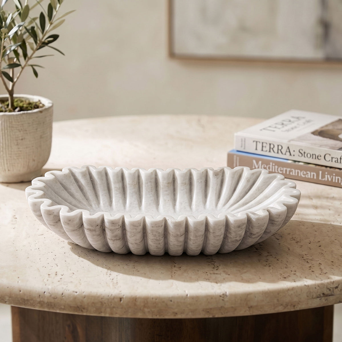 Decorative round bowl with vertical ridges, light gray finish on tabletop.