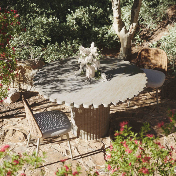 Round washed travertine outdoor dining table with cylindrical pedestal base