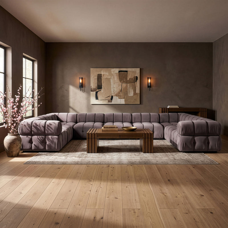 Velvet sectional sofa with tufted cushions, dark gray fabric and rounded chaise ends