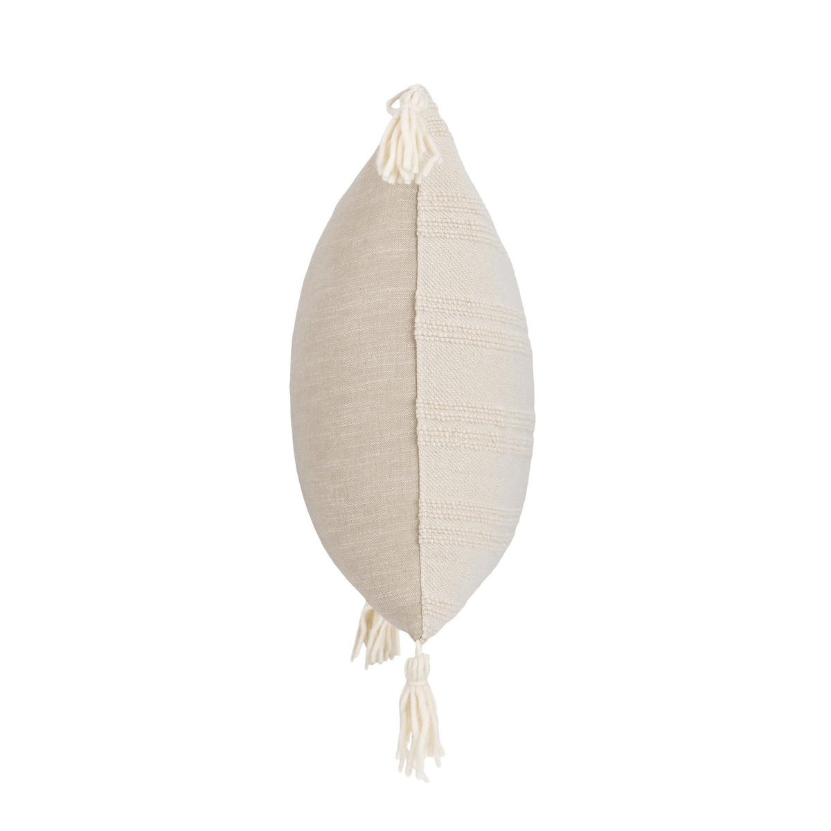 Natural pillow with vertical seam and hanging tassels on corners