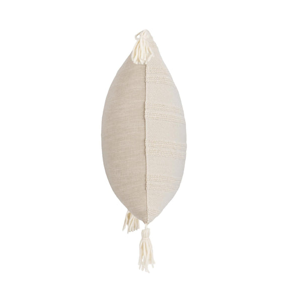 Natural pillow with vertical seam and hanging tassels on corners