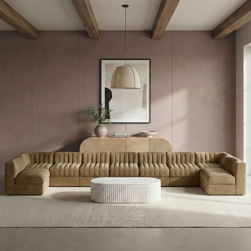 Light brown armless velvet modular sectional with tufted back cushions and chaise corner pieces