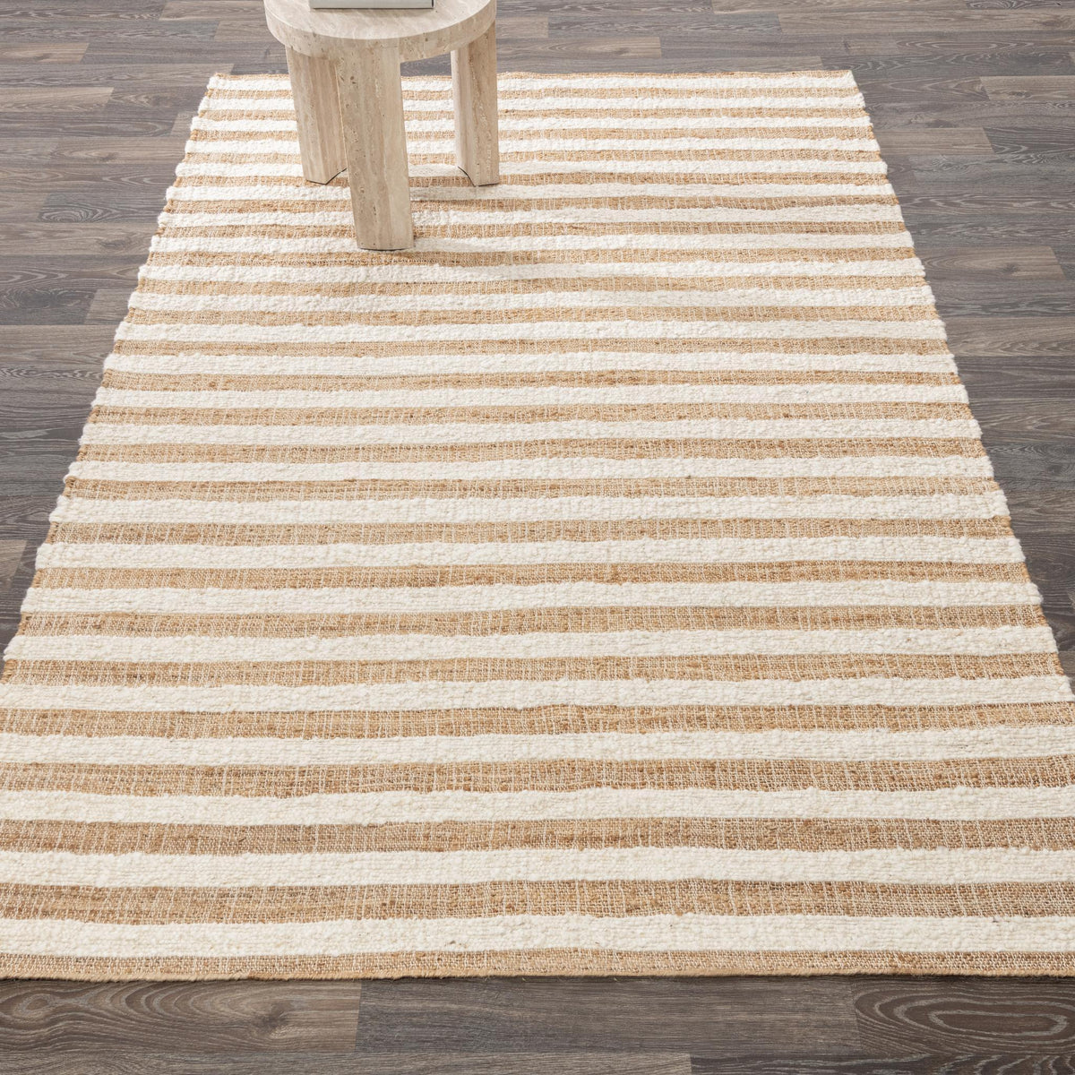 Natural stripe area rug with horizontal bands under a partial chair leg