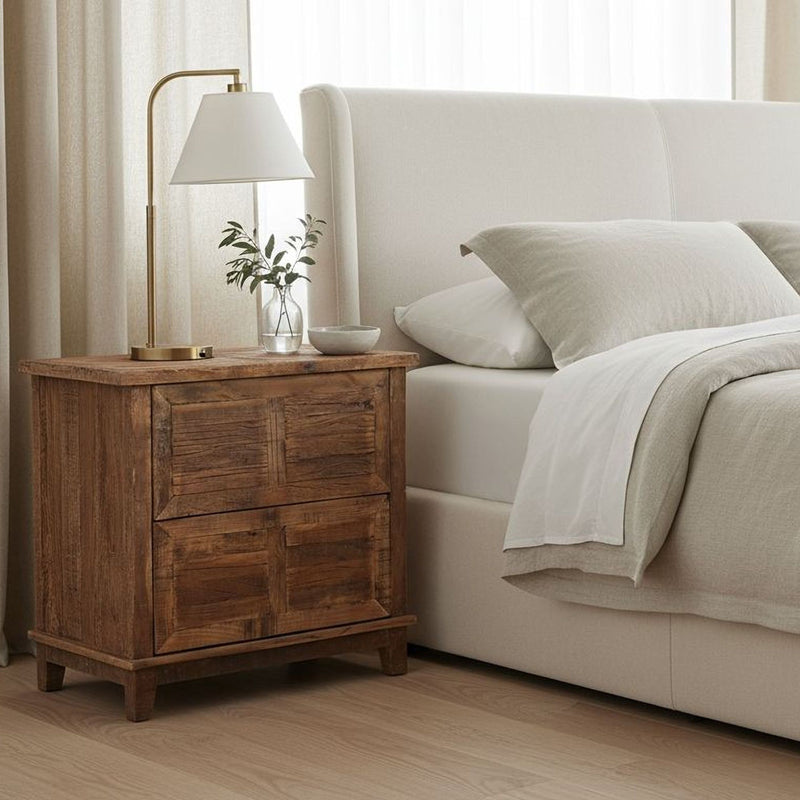 Brown wooden nightstand with two drawers, lamp on top.