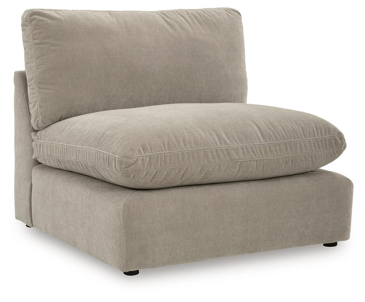 Light beige sectional chaise with one back pillow and rounded seat cushion.