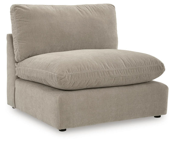 Light beige sectional chaise with one back pillow and rounded seat cushion.