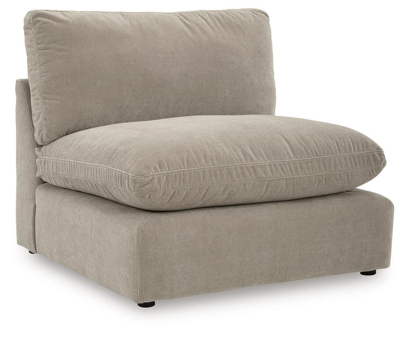 Light beige sectional chaise with one back pillow and rounded seat cushion.