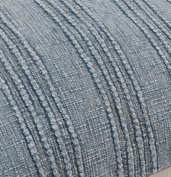 Close-up of blue woven pillow fabric with raised vertical stripe pattern