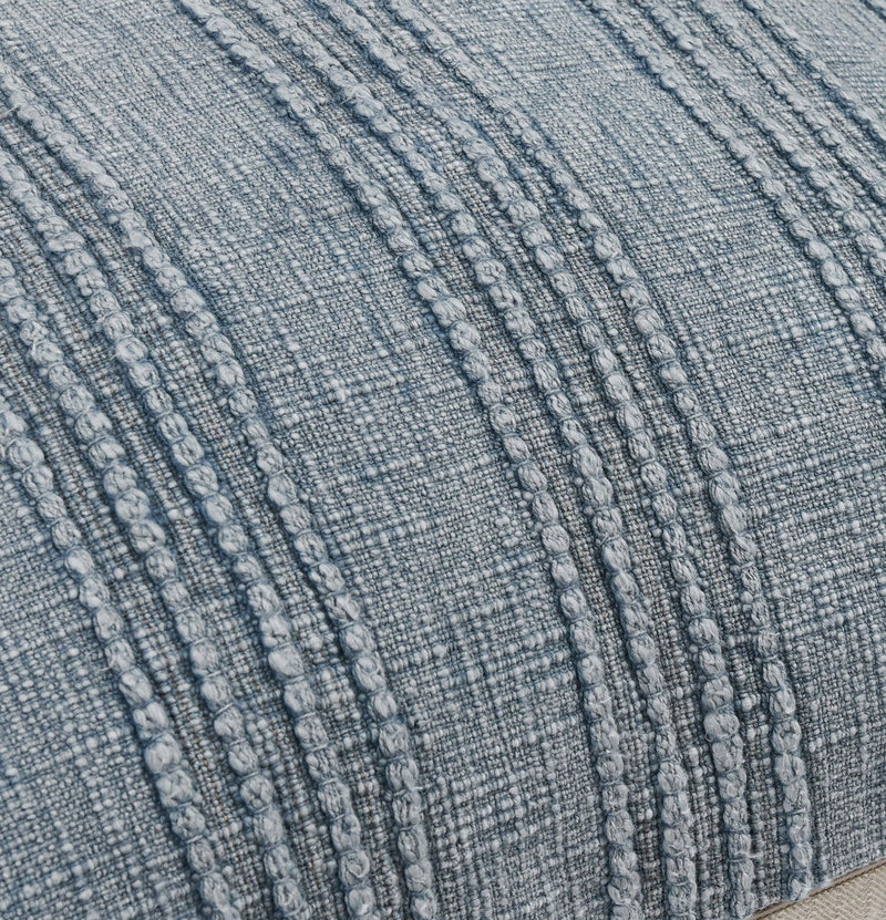 Close-up of blue woven pillow fabric with raised vertical stripe pattern