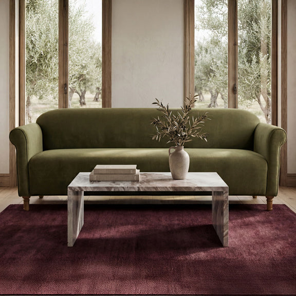 Dark green faux mohair sofa with rounded arms and plush seat cushions