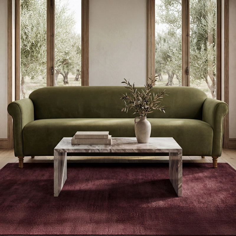 Dark green faux mohair sofa with rounded arms and plush seat cushions